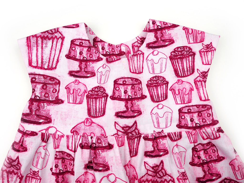 Close up of handmade girl's dress in cupcake print fabric