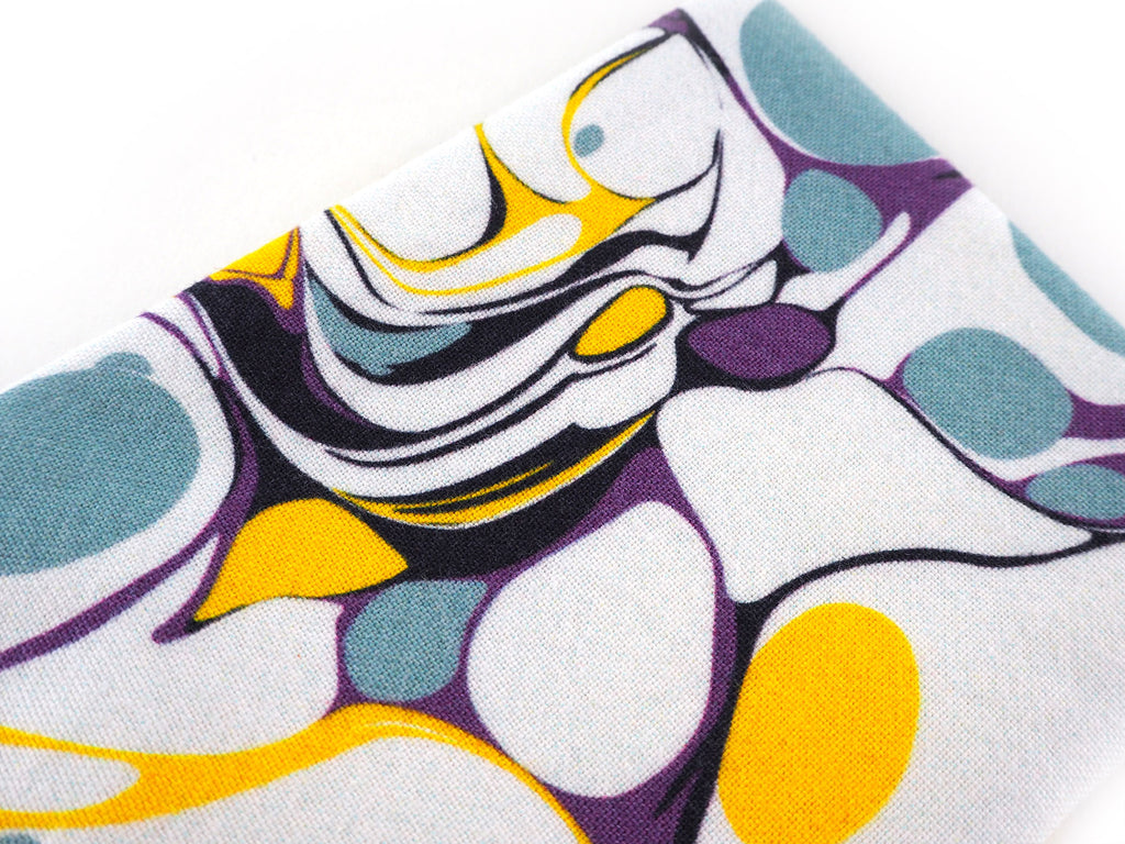 Handmade glasses case in white and yellow marble print close up
