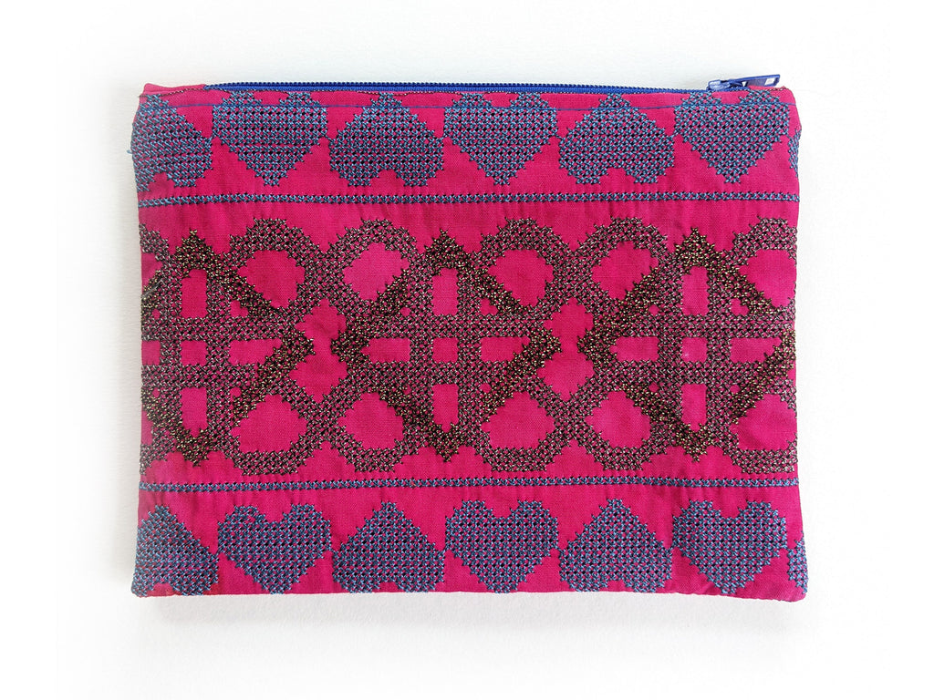 Intricately embroidered pink purse with blue zip