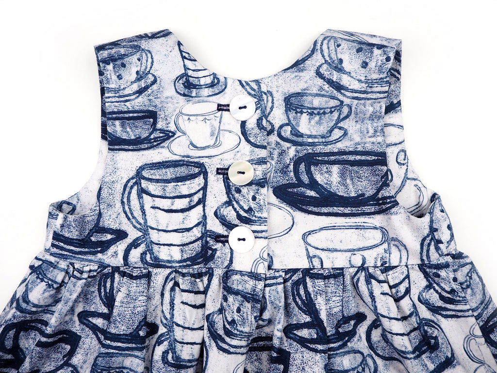 Blue and white teacup print dress with shell buttons
